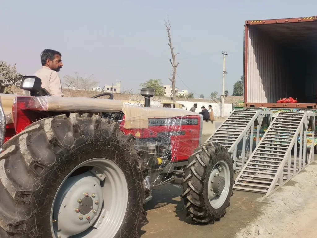 Massey Ferguson MF 385 tractor being loaded for export shipment